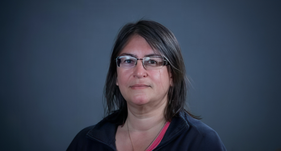 Headshot of Gabriella Giannachil against grey background.